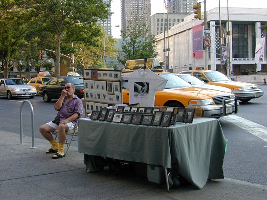 I love this shot. Lincoln Center in the background, vendor picking his teeth.
