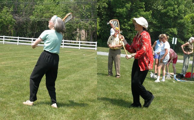 Cynthia firing off a shot, Lucia getting ready to throw, Larry Holofcener in the background fiddling with his video…