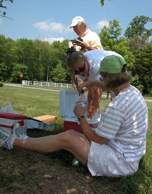 Larry, Julia, and Trish getting water and oranges thoughtfully supplied by Julia.
